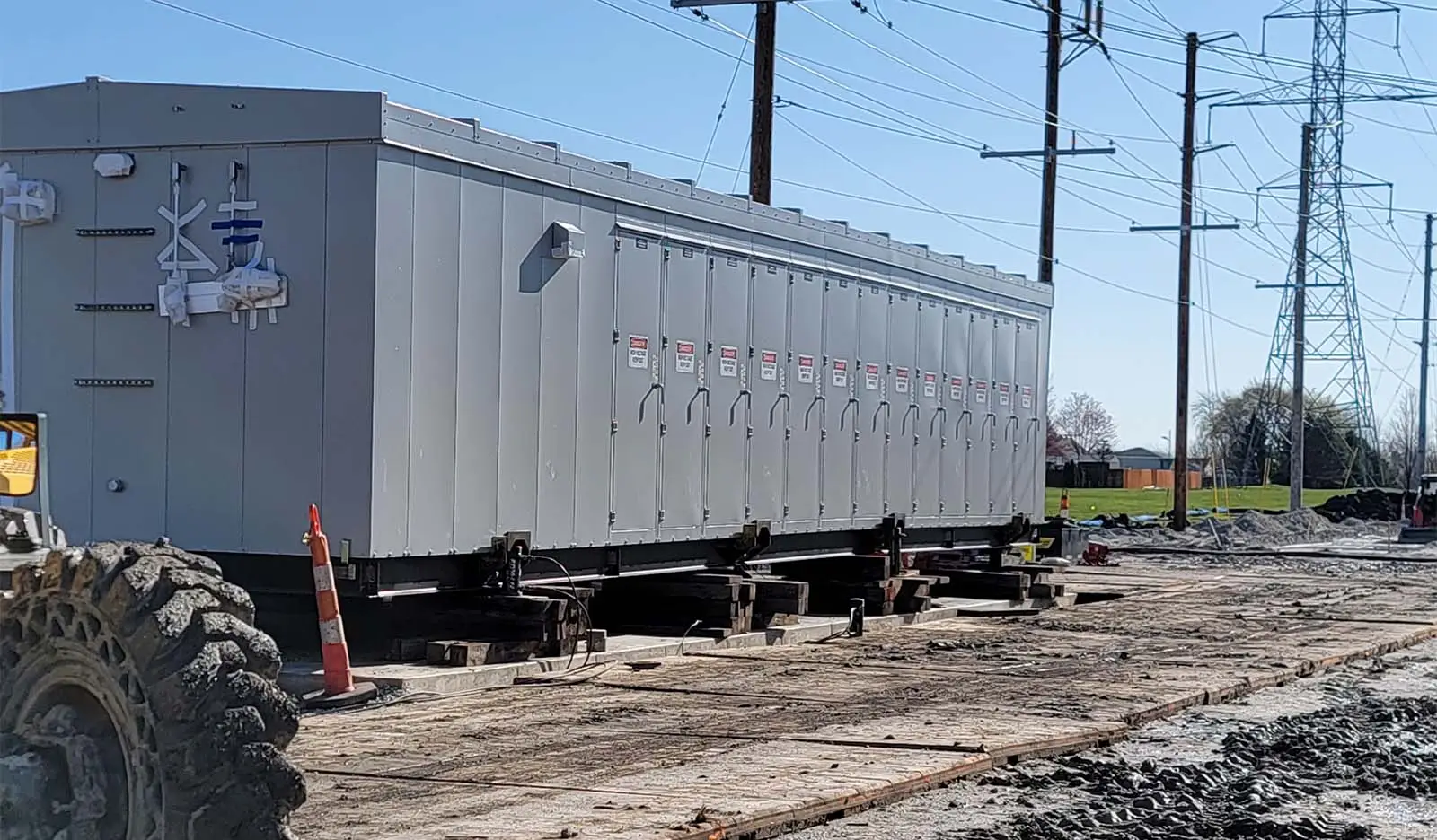 Large switchgear outdoors with power lines in the background